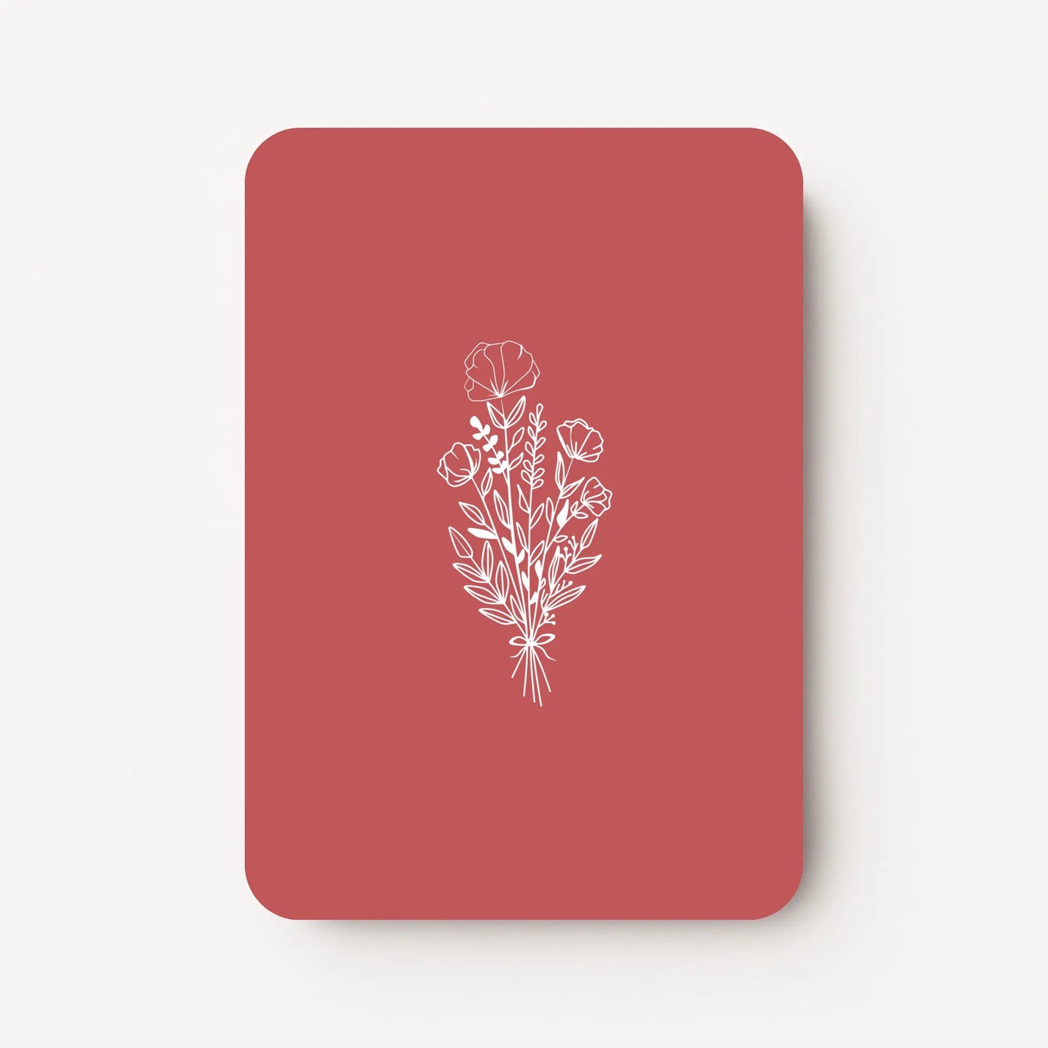 Staande bedankkaart met witte bloemen line art op dieprode achtergrond, flatlay op witte ondergrond.