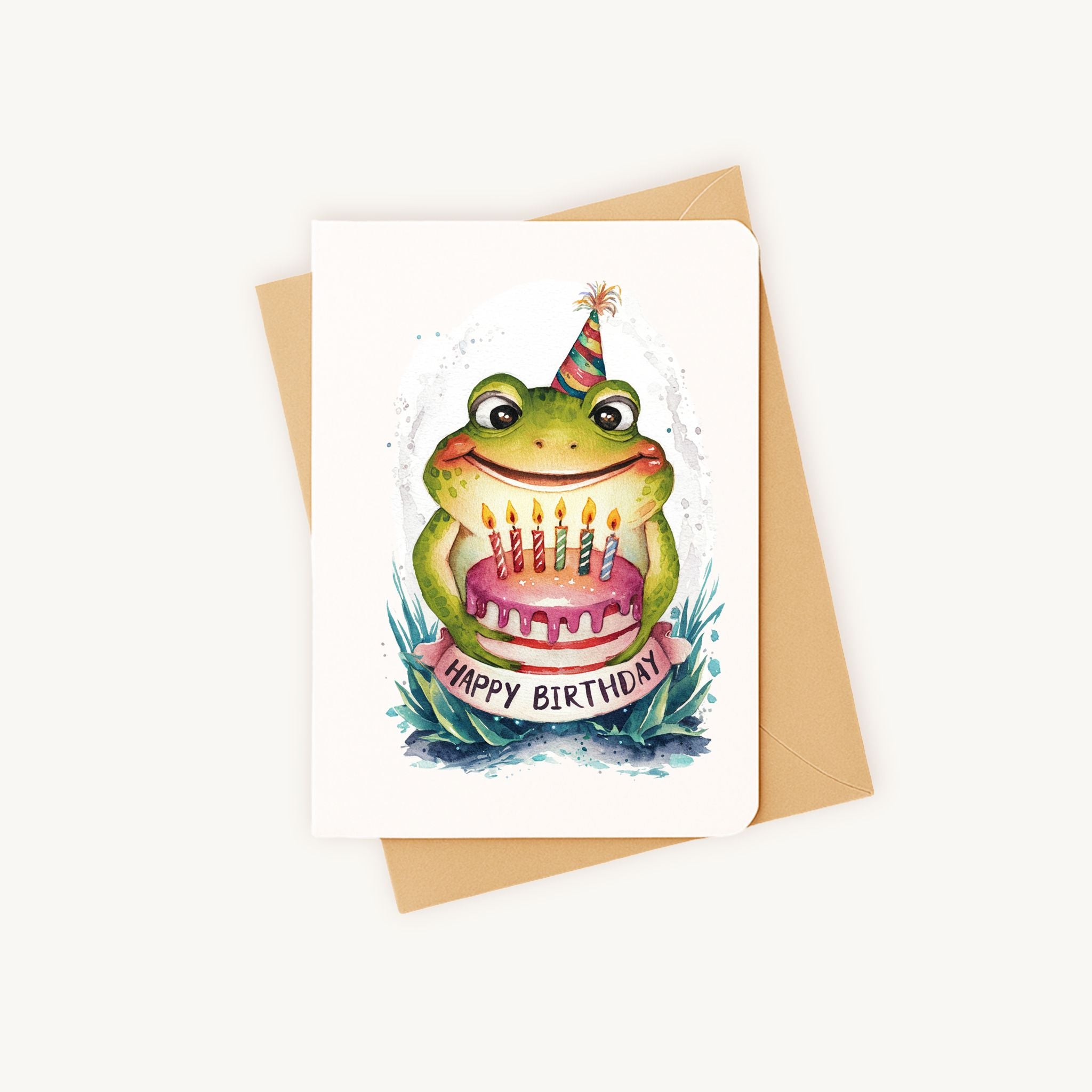 Liggende verjaardagskaart kikker met feesthoedje, samen met kraft envelop.