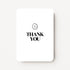 Staande witte bedankkaart met zwarte tekst "THANK YOU" en een zwarte smiley.