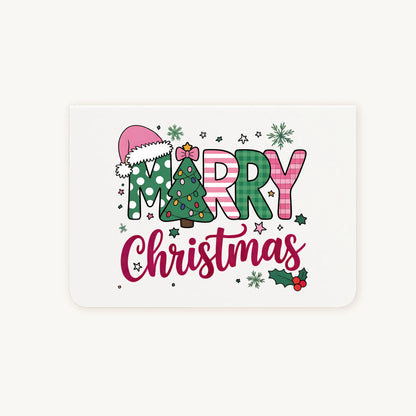 Liggende dubbelgevouwen kerstkaart met kleurrijke watercolor kerstillustratie met kerstboom, kerstmuts en sierlijke tekst ‘Merry Christmas’, flatlay op lichte achtergrond.