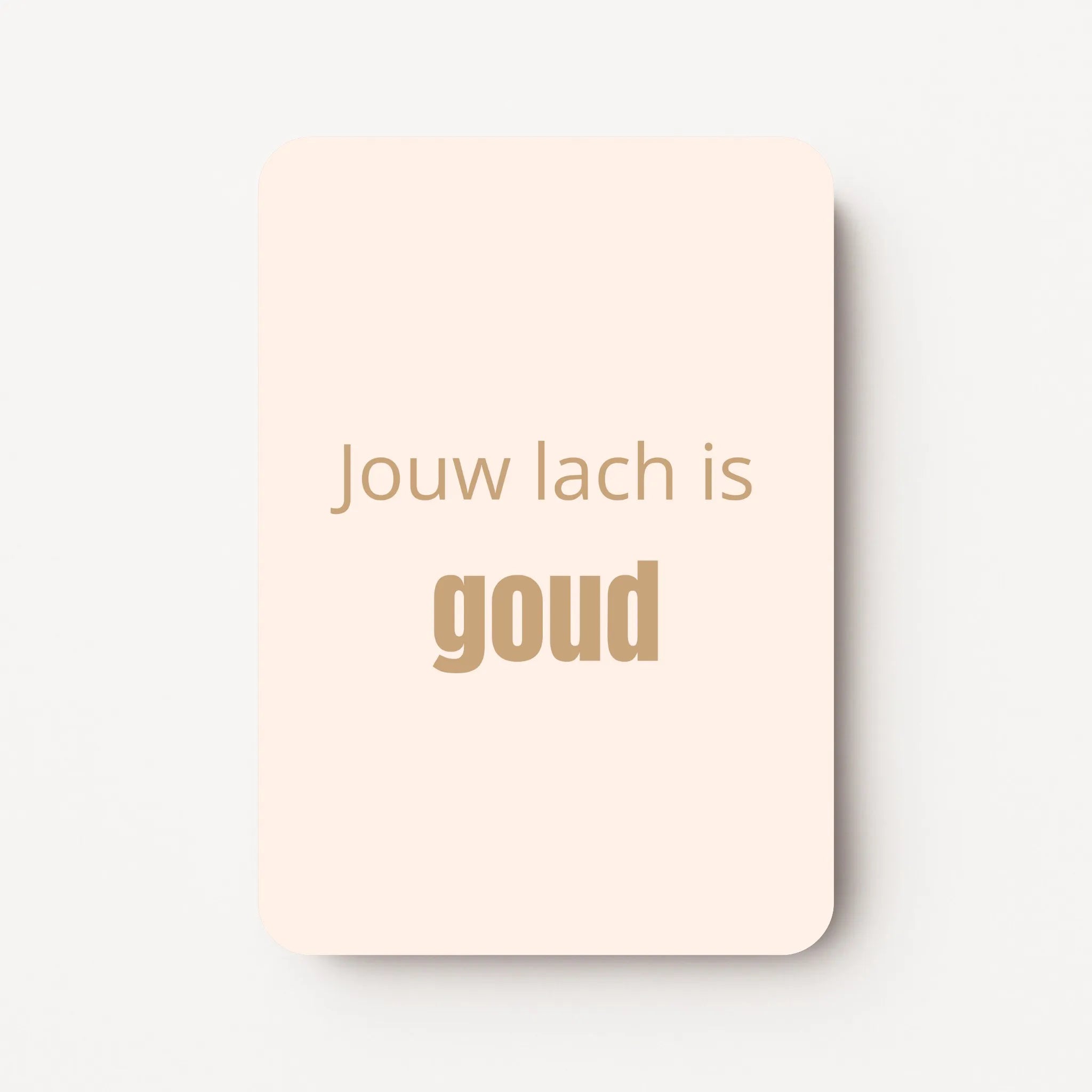 Staand minikaartje met goudbeige tekst ‘Jouw lach is GOUD’, minimalistisch ontwerp op een zachte perzik-witte achtergrond, flatlay op witte ondergrond.
