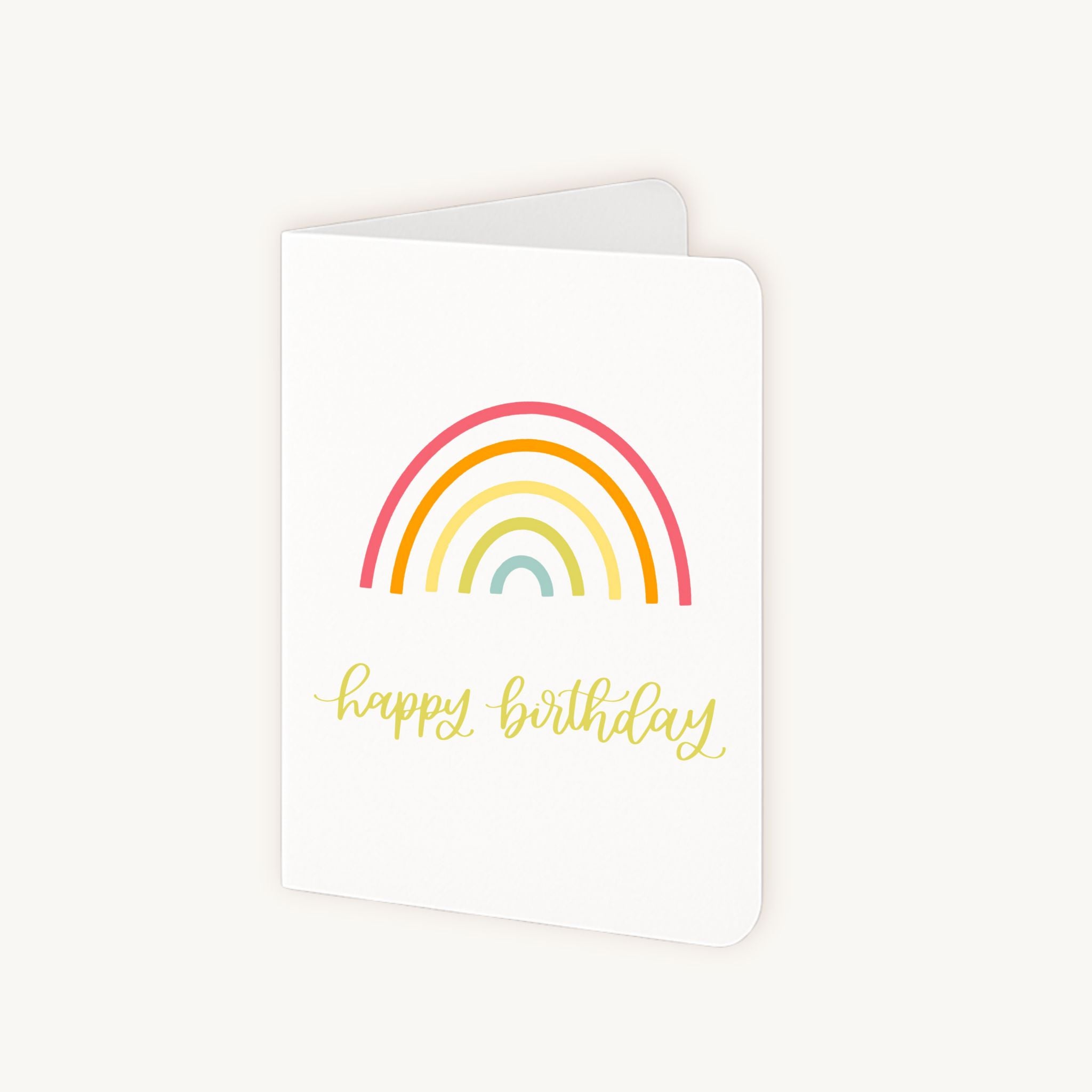 Half geopende verjaardagskaart met regenboog en witte binnenkant