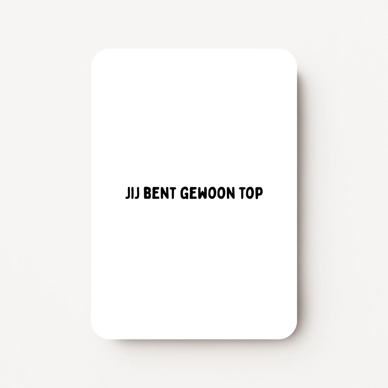 Staande zomaarkaart met zwarte tekst ‘Jij bent gewoon top’, minimalistisch ontwerp op witte achtergrond, flatlay op witte ondergrond.